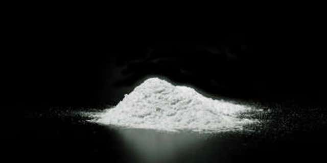 FILE- Cocaine sitting on a table. A Pennsylvania police officer was arrested after allegedly attempting to buy cocaine.