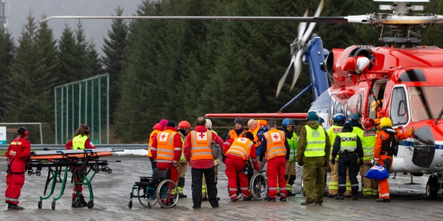 Passengers are helped from a rescue helicopter in Fraena, Norway, on Sunday after being rescued from the Viking Sky cruise ship.