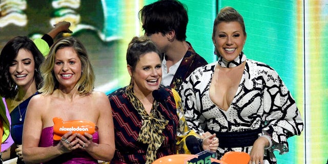 Candace Cameron-Bure, from left, Andrea Barber and Jodie Sweetin, from the cast of "Fuller House," accept the award for favorite funny TV show at the Nickelodeon Kids' Choice Awards.