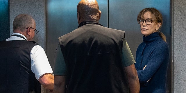 Actress Felicity Huffman is seen inside the Edward R. Roybal Federal Building and U.S. Courthouse in Los Angeles, on March 12, 2019. - Two Hollywood actresses including Oscar-nominated "Desperate Housewives" star Felicity Huffman are among 50 people indicted in a nationwide university admissions scam, court records unsealed in Boston on March 12, 2019 showed. The accused, who also include chief executives, allegedly cheated to get their children into elite schools, including Yale, Stanford, Georgetown and the University of Southern California, federal prosecutors said.Huffman, 56, and Lori Loughlin, 54, who starred in "Full House," are charged with conspiracy to commit mail fraud and honest services mail fraud. A federal judge set bond at $250,000 for Felicity Huffman after she was charged in a massive college admissions cheating scandal. (Photo by DAVID MCNEW / AFP) (Photo credit should read DAVID MCNEW/AFP/Getty Images)