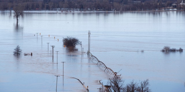 Looking southwest toward Waterloo, Neb., high waters from the Elkhorn River cover Maple Street on Saturday. (Jeff Bundy/Omaha World-Herald via AP)