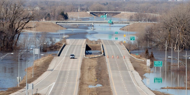 Dodge street is closed from flood waters on Saturday March 16, 2019 in Omaha Neb. (Jeff Bundy/Omaha World-Herald via AP)