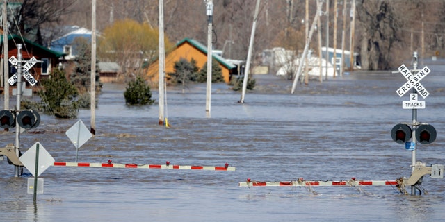 A railroad crossing is flooded with water from the Platte River, in Plattsmouth, Neb., Sunday, March 17, 2019. (AP Photo/Nati Harnik)