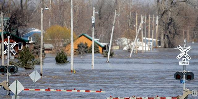 A tyrannise channel is flooded with H2O from a Platte River, in Plattsmouth, Neb., Sunday, Mar 17, 2019. (AP Photo/Nati Harnik)