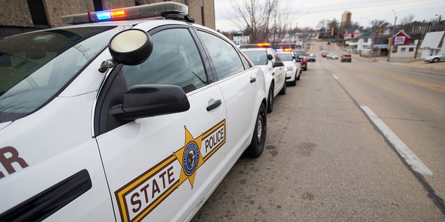 Illinois State Police vehicles line up outside the Stephenson County Coroner's office on Thursday in Freeport after a procession to deliver the body of Trooper Brooke Jones-Story, who was struck and killed by a truck while conducting a traffic stop earlier in the day. (Scott P. Yates/Rockford Register Star via AP)