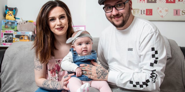 Jade Jeanes and her husband Joshua, with their daughter Disney.