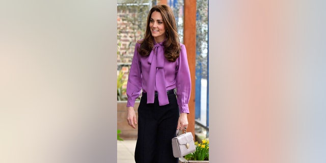Kate Middleton wore a purple Gucci blouse to the event.