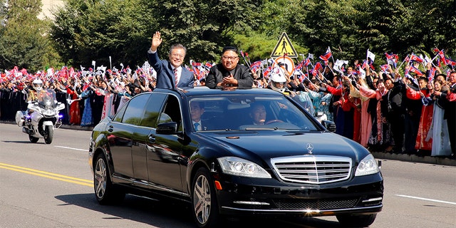 FILE PHOTO: South Korean President Moon Jae-in and North Korean leader Kim Jong Un wave during a car parade in Pyongyang, North Korea, September 18, 2018. Pyeongyang Press Corps/Pool via REUTERS/File Photo - RC1E579359C0