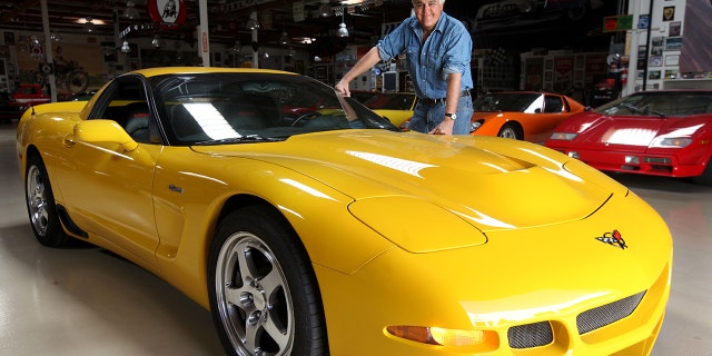Jay Leno stands next to a Corvette Z06 at Jay's garage in Burbank.