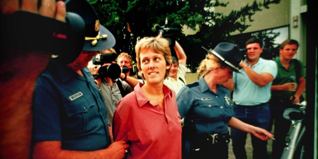 Diane Downs is escorted out of state police headquarters in Salem, Ore., on July 21, 1987.