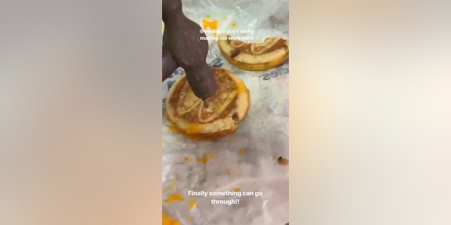 Edl tried using a hammer to push a nail into the tough bun.
