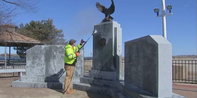 Officials spent Monday trying to clean the oily substance off the monument.