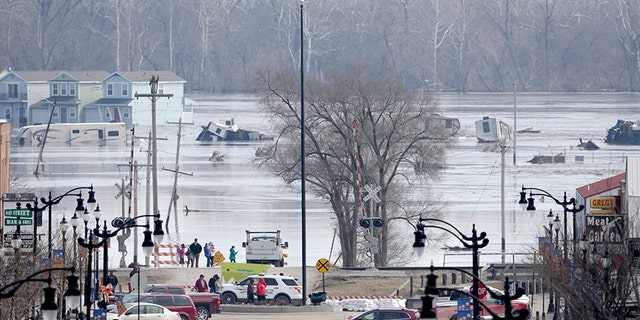 People view the rising waters from the Platte and Missouri rivers which flooded areas of Plattsmouth, Neb., in March.