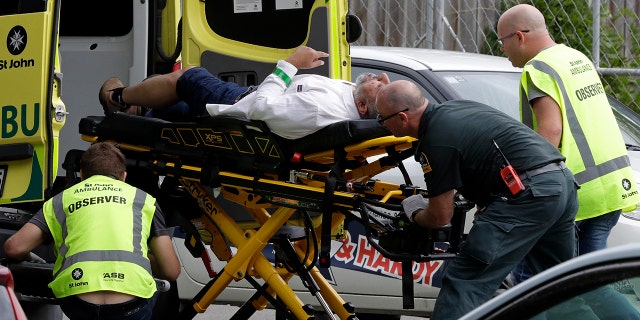 Ambulance staff take a man from outside a mosque in central Christchurch, New Zealand, Friday, March 15, 2019. (AP Photo/Mark Baker)