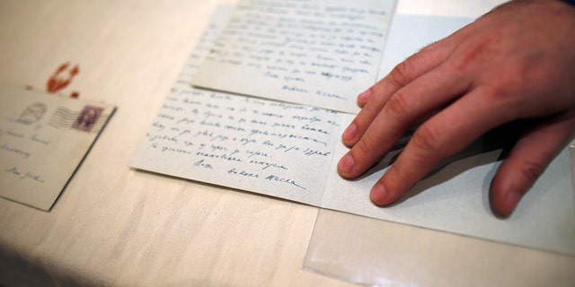 Viktor Lazic from Adligat group displays two letters written by 19th century inventor and electricity pioneer Nikola Tesla in Belgrade, Serbia, Thursday, March 7, 2019. A private culture society in Serbia has made public two letters written by Serb-American inventor and electricity pioneer Nikola Tesla. The Adligat group has told The Associated Press they recently obtained the letters from a collector and verified their authenticity with multiple sources. (AP Photo/Darko Vojinovic)