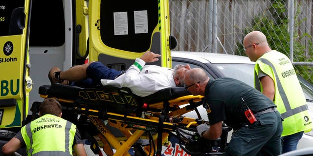 Ambulance staff take a man from outside a mosque in central Christchurch, New Zealand, Friday, March 15, 2019. Multiple people were killed in mass shootings at two mosques full of worshippers attending Friday prayers on what the prime minister called "one of New Zealand's darkest days," as authorities detained four people and defused explosive devices in what appeared to be a carefully planned attack