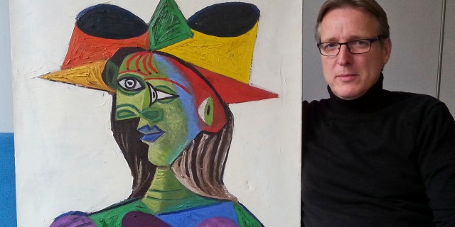 This image released on Tuesday March 26, 2019 by Arthur Brand, shows Dutch art detective Arthur Brand with "Buste de Femme", a recovered Picasso painting.
