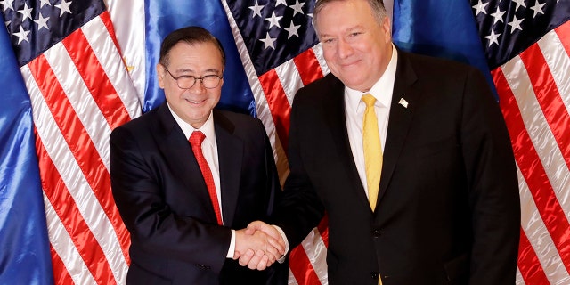 Philippine Foreign Affairs Secretary Teodoro Locsin Jr., left, and U.S. Secretary of State Mike Pompeo shake hands prior to their bilateral meeting in suburban Pasay city, southeast of Manila, Philippines Friday, March 1, 2019. (AP Photo/Bullit Marquez)