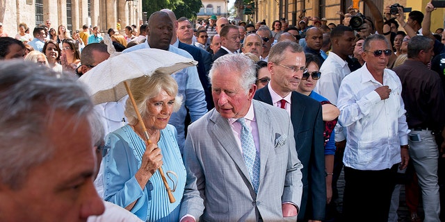 Britain's Prince Charles, the Prince of Wales, center, and his wife Camilla, Duchess of Cornwall, take a guided tour of the historical area of Havana, Cuba, Monday, March 25, 2019.