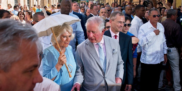 Britain's Prince Charles, the Prince of Wales, center, and his wife Camilla, Duchess of Cornwall, take a guided tour of the historical area of Havana, Cuba, Monday, March 25, 2019.