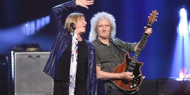 Inductee Joe Elliott, of Def Leppard, left, performs with Brian May, of Queen, at the Rock and Roll Hall of Fame induction ceremony.