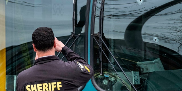 Bullet holes can be seen in the driver's side window of a Metro Bus in Seattle after a shooting, Wednesday March 27, 2019. (Associated Press)