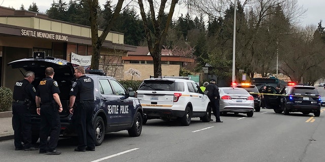 Seattle police work at the scene of a shooting in Seattle on Wednesday, March 27, 2019. (AP Photo/Gene Johnson)