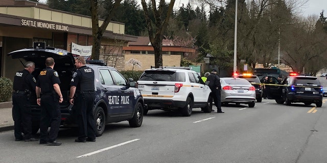 Seattle police work at the scene of a shooting in Seattle on Wednesday, March 27, 2019. (AP Photo/Gene Johnson)