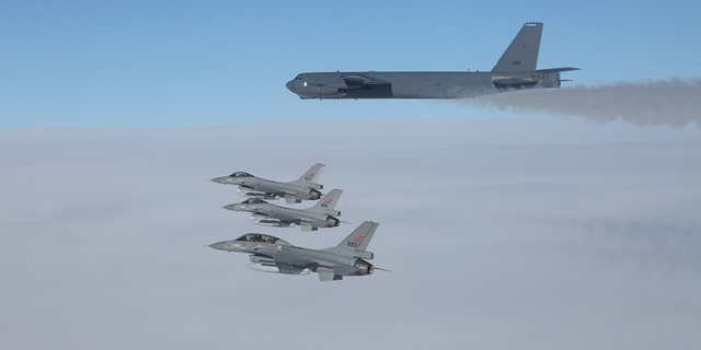 A U.S. B-52 Stratofortresses, deployed from Barksdale Air Force Base, La., flies in formation with three Norwegian F-16 Fighting Falcons over Norway, March 28, 2019.