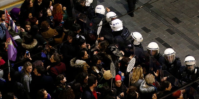 Turkish police block protesters wanting to hold a march for the International Women's Day, in Istanbul, Friday, March 8, 2019. The day has been sponsored by the United Nations since 1975 as millions around the world are demanding equality amid a persistent salary gap, violence and widespread inequality. (AP Photo/Emrah Gurel)