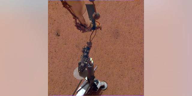 NASA's InSight lander deploys its heat probe on Mars on Feb. 12, 2019.