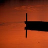 A man is silhouetted at dusk as he fishes on a dock at Shawnee Mission Park, in Lenexa, Kansas, March 11, 2019. 