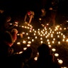 People participate in fire rituals during the spring equinox celebration at Cathedral Square in Vilnius, Lithuania, March 20, 2019. 