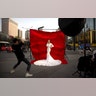 A woman in wedding attire poses for a photo portrait along a busy street in Xi'an in northwestern China's Shaanxi Province, March 28, 2019. 