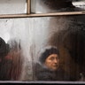 Commuters are seen through the window of a public bus as they travel in central Vinnytsia, Ukraine, March 27, 2019. 