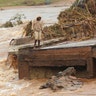 A man stands on the edge of a collapsed bridge in Chimanimani, about 600 kilometers southeast of Harare, Zimbabwe, March 18, 2019.