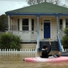 A woman with a dog sails a kayak on a flooded street in Guerneville, north of San Francisco, Feb. 27, 2019. 