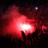 PSG supporters set off flares after their team scored during their French League One soccer match against Olympique Marseille in Paris, March 17, 2019. 
