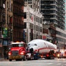 A vintage TWA Lockheed Constellation airplane is transported along 6th Avenue on its way to Times Square in New York City, March 23, 2019.