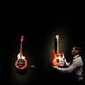 A technician arranges guitars from the collection of David Gilmour, guitarist, singer and songwriter of Pink Floyd, at Christie's auction rooms in London, March 27, 2019. 