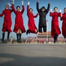Ushers leap as they pose for a group photo during a meeting one day ahead of the opening session of China's National People's Congress at the Great Hall of the People in Beijing, March 4, 2019.