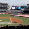 A large flag is unfurled during the national anthem before an opening day baseball game between the New York Yankees and the Baltimore Orioles at Yankee Stadium in New York, March 28, 2019.