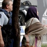 Police escort people away from outside one of the mosques . (AP Photo/Mark Baker)