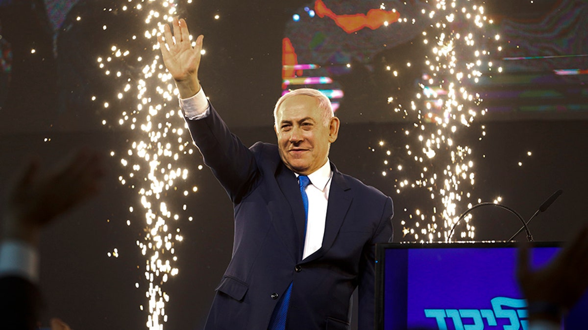 Israel's Prime Minister Benjamin Netanyahu waves to his supporters after polls for Israel's general elections closed in Tel Aviv, Israel, on Wednesday.