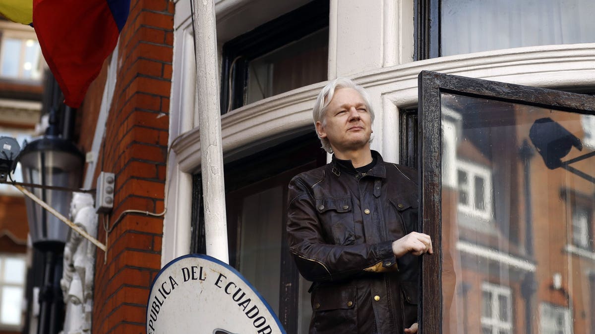 WikiLeaks founder Julian Assange greets supporters outside the Ecuadorian Embassy in London, May 19, 2017. (Associated Press)