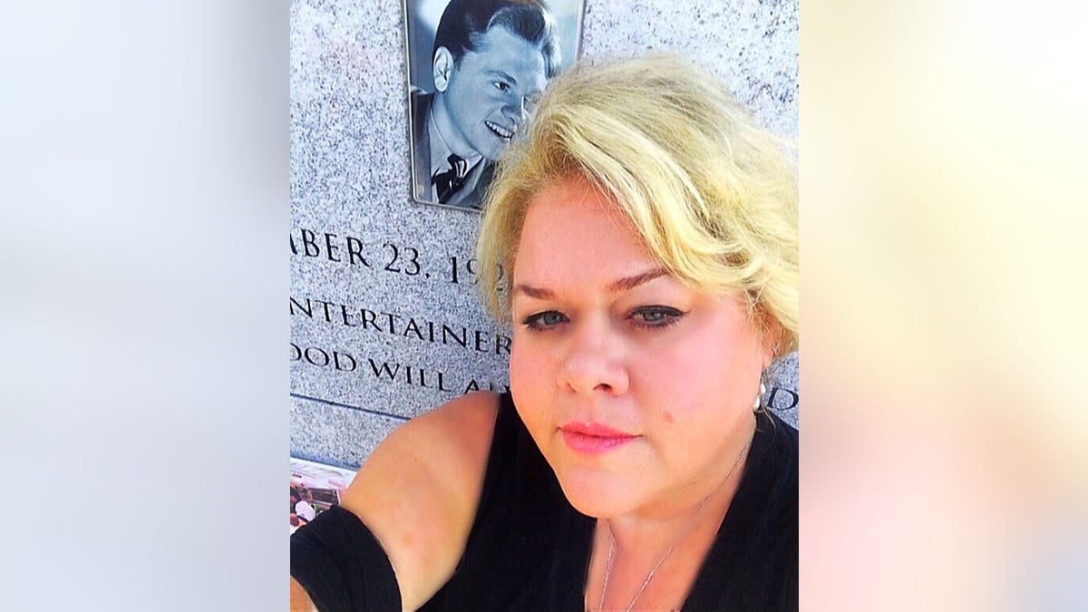Kelly Rooney at her father's gravesite.