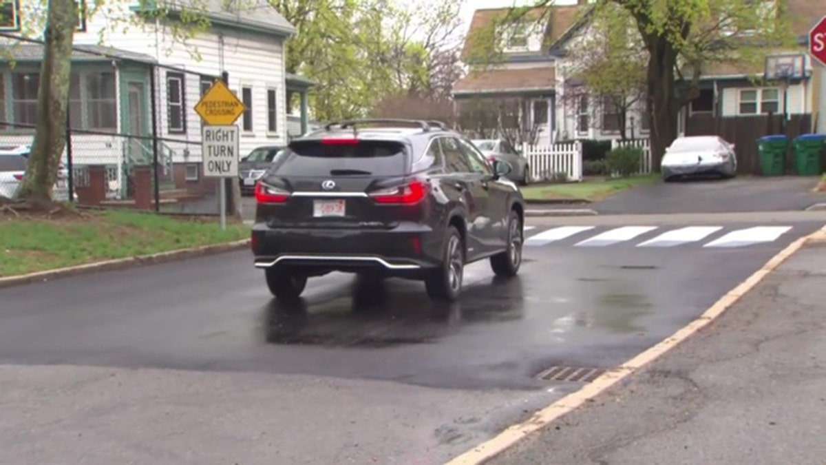 A car stops at the newly designed 3D crosswalk. The walkway was designed by a pair of fourth graders in Massachusetts
