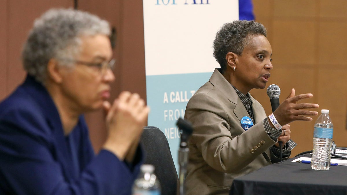 In this March 24, 2019 photo, Chicago mayoral candidate Lori Lightfoot, right, participates in a candidate forum in Chicago. Lightfoot and Toni Preckwinkle, left, are competing to make history by becoming the city's first black, female mayor. On issues their positions are similar. But their resumes are not, and that may make all the difference when voters pick a new mayor on Tuesday, April 2, 2019. (AP Photo/Teresa Crawford)