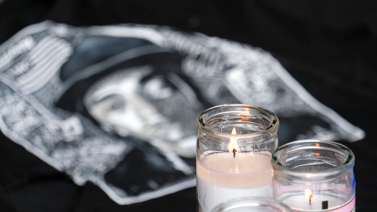 Candles appear at a memorial for Nipsey Hussle in the parking lot of his Marathon Clothing store in Los Angeles. (Associated Press)