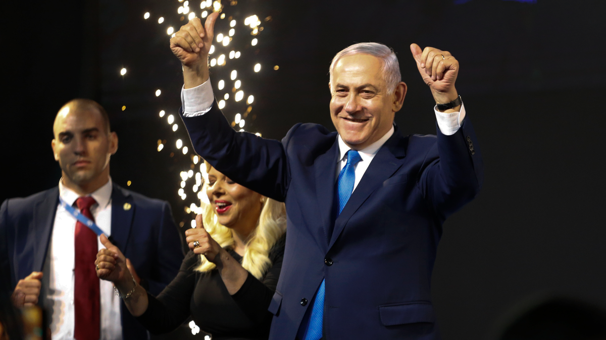 Israel's Prime Minister Benjamin Netanyahu waves to his supporters after polls for Israel's general elections closed in Tel Aviv, Israel, Wednesday, April 10, 2019. (AP Photo/Ariel Schalit)
